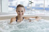 Portrait of a smiling beautiful woman in a hot tub