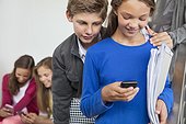 Students using mobile phones in a school