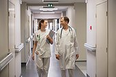 Doctor and female nurse walking in the corridor of a hospital