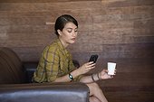 Young woman using a mobile phone during office break