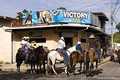Costa Rica - Liberia - Horse riders during a traditional parade stopping front of a bar  to have a drink