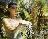 Woman in a bathing suit behind a waterfall