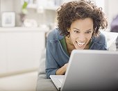 Woman laughing and using laptop
