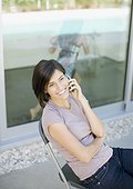 Woman talking on cell phone on patio