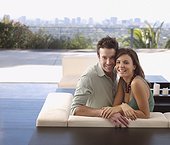 Couple relaxing on modern balcony furniture