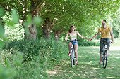 Couple holding hands and riding bicycles