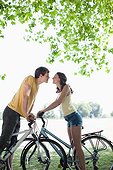 Couple on bicycle stopping and kissing