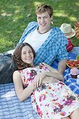 Couple having picnic and laying on grass