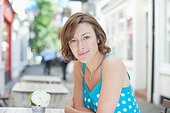 Smiling woman sitting at cafe table