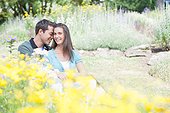 Smiling couple sitting in park