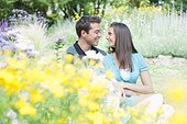 Smiling couple sitting in park