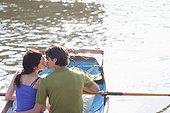 Couple kissing in rowboat on lake