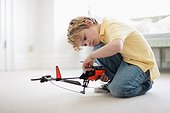 Boy playing with toy helicopter