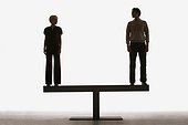 Two people standing on top of a plank