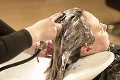 Hair stylist washing clients hair