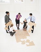 Business people doing puzzle in office