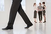 Businessmans feet walking in office