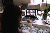 Young woman on video call on laptop at home