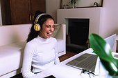 Young woman on video call on laptop, laughing