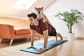 Man exercising with pet dog on his back