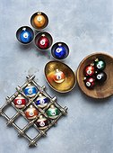 Christmas ornaments in gold, wood and silver bowls