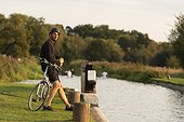 Cyclist stopping beside canal