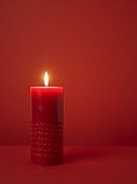 Christmas candle on a red background