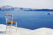 Old chair on rooftop, Santorini, Cyclades, Greece