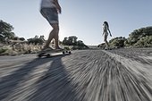 People skateboarding on the road.