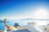 Young woman sunbathing, Santorini, Cyclades, Greece