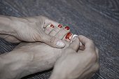 Woman removing toe nail polish. Close-up view