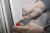 Construction man cutting plasterboard panel