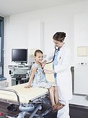 doctor examing child, using stethoscope