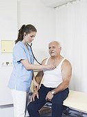 female doctor examing senior man, using stethoscope