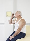 senoir man using asthma inhaler