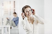 Berlin, Germany, Young woman wearing headphones