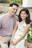 Daughter with Father Wearing Flower Over His Ear