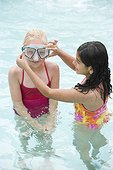 Girl Helping Friend Put on Swim Mask