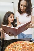 Mother and Daughter Looking at a Recipe Book