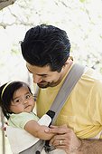 Father with Baby Daughter in Cloth Carrier