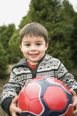 Young Boy Holding a Soccer Ball