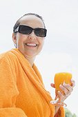 Woman Wearing Bathrobe Holding Orange Juice