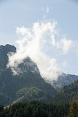 Wispy cloud over mountain landscape