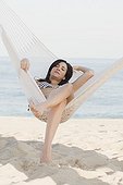 Cuban woman laying in hammock on beach
