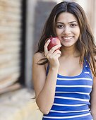 Middle Eastern woman holding apple