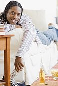 African man watching television on sofa