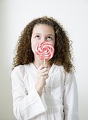 Mixed race girl with oversized lollipop