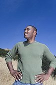 Mixed race man standing in rural area
