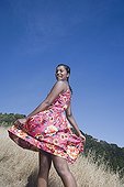 Mixed race woman in sundress in rural area