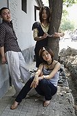 Chinese friends standing on sidewalk
